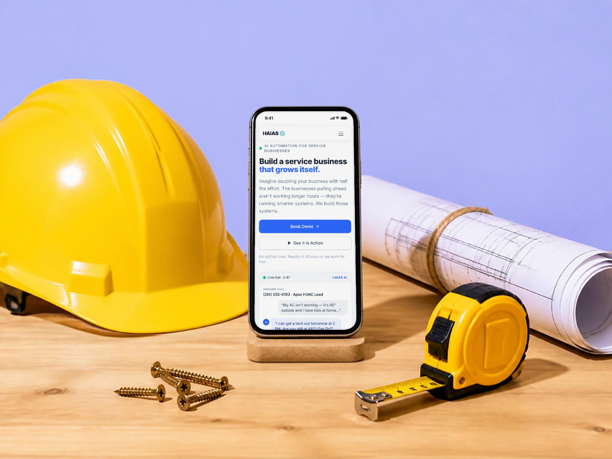 HAIAS Solutions' new website on a phone on a workbench, beside a hard hat, tape measure and blueprints
