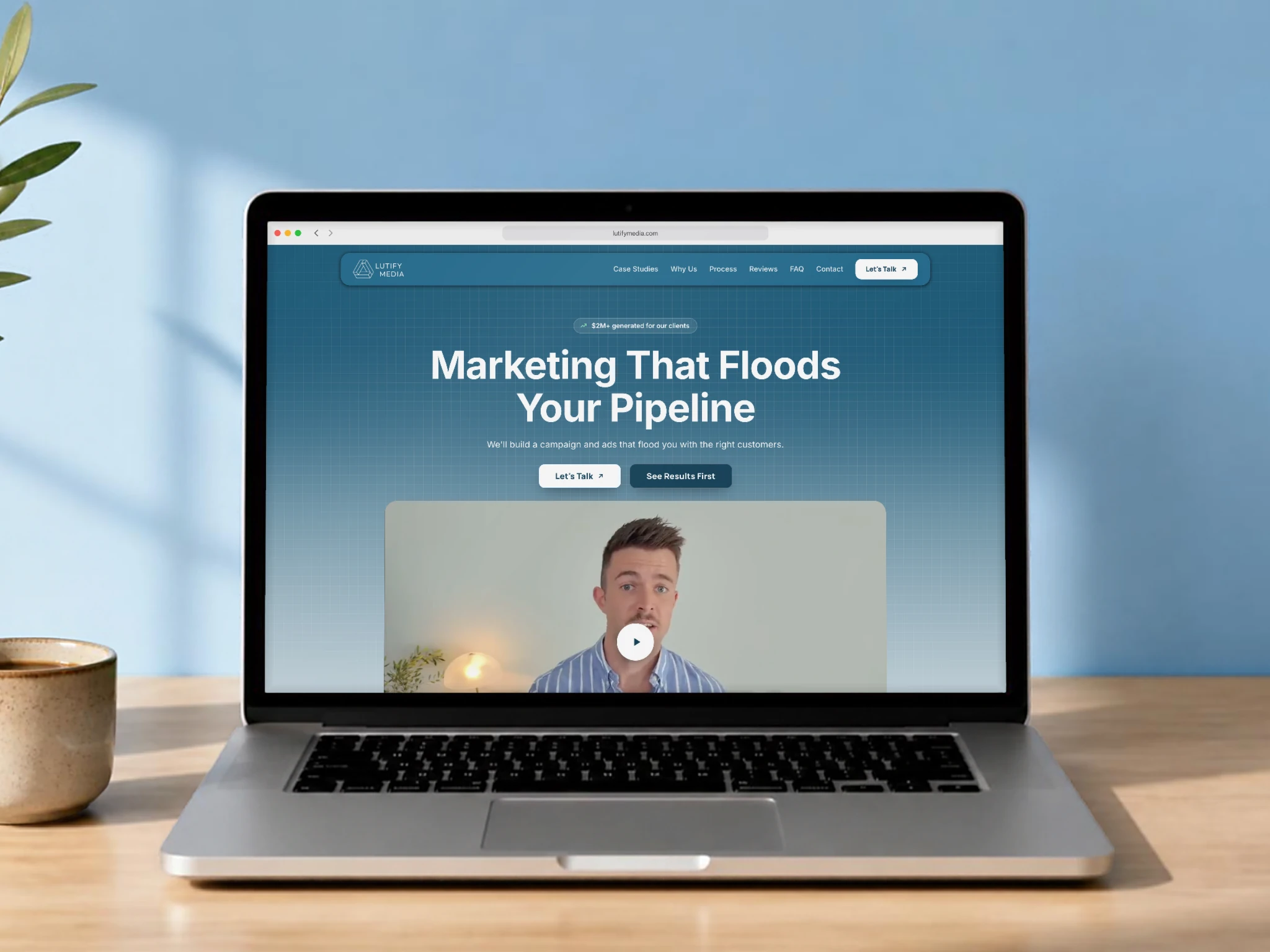 Lutify Media's new website on a laptop on a wooden table